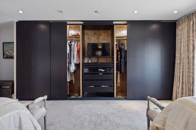 Primary bedroom's custom closet, balcony to the side overlooks the lake. | Image 24