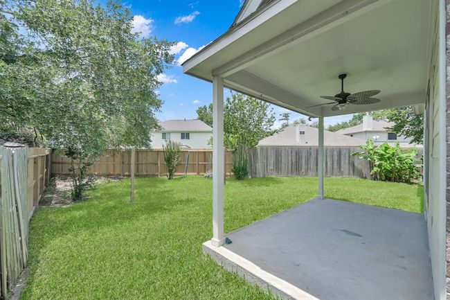 Enjoy outdoor living on the covered back patio, complete with a tropical style ceiling fan and mister that will keep you COOL all summer long! | Image 33