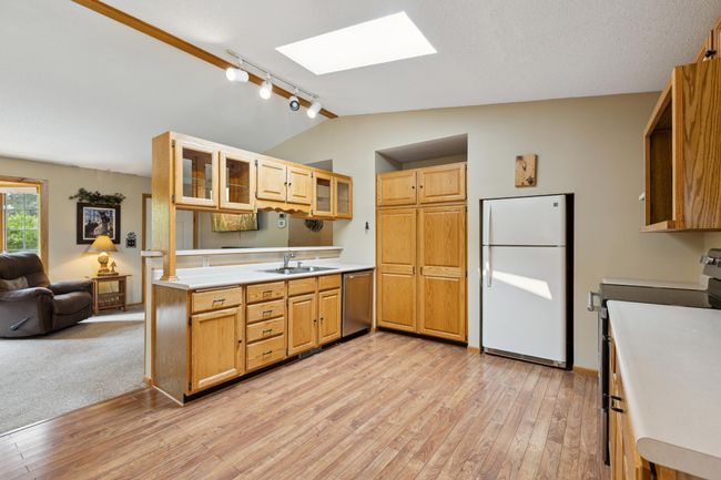 The kitchen has a nice see through area to the living room | Image 17