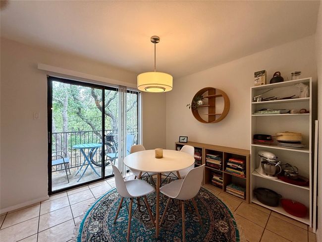 Dining room with light tile patterned floors | Image 4