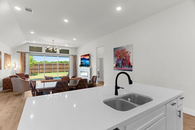 Kitchen with a sink, light countertops, open floor plan, light wood-style floors, and recessed lighting | Image 11