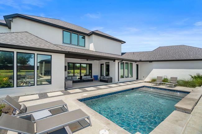 Rear view of property featuring an outdoor living space, a ceiling fan, a patio, and a shingled roof | Image 35