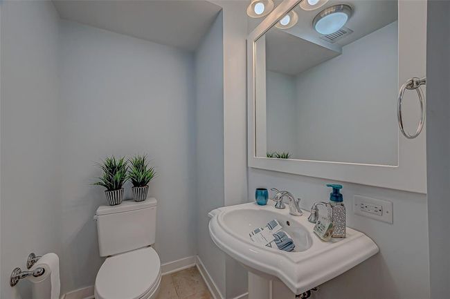 Elegant guest bathroom with modern touches. | Image 16