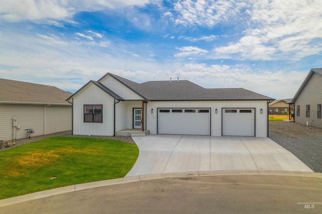 Modern inspired farmhouse featuring a garage, concrete driveway, and a front yard | Image 36