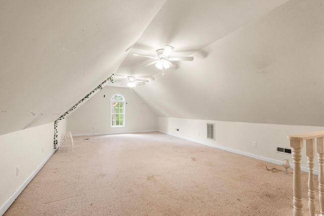 Additional living space with a ceiling fan, vaulted ceiling, and carpet floors | Image 19