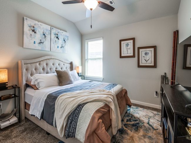 Bedroom featuring vaulted ceiling, baseboards, carpet floors, and a ceiling fan | Image 25