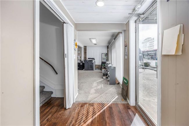 Hall featuring stairs, wood finished floors, and carpet floors | Image 4