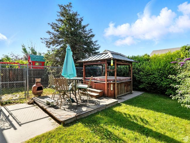 View of yard with a hot tub, a gazebo, and a patio | Image 23