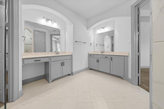 Bathroom featuring marble finish floor, two vanities, and a sink | Image 13