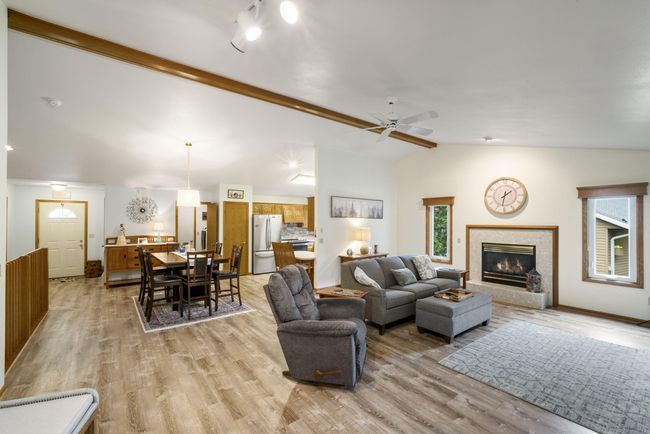 Open Concept Layout Features Soaring Cathedral Ceilings, Luxury Vinyl Flooring, and a Bright Living Area Ideal for Entertaining! | Image 9