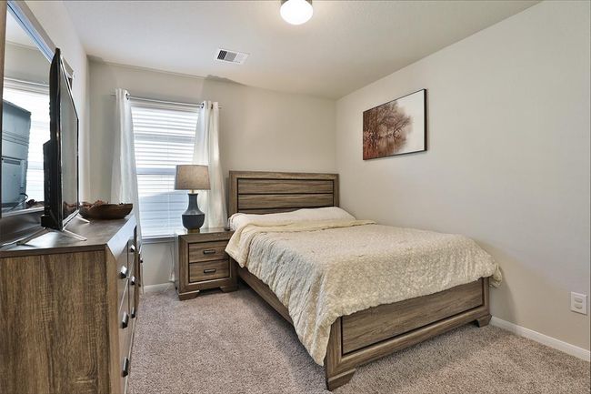 Another secondary bedroom filled with natural light. | Image 23