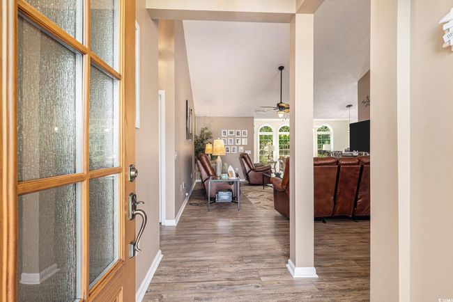 Foyer entrance with wood finished floors, a ceiling fan, and baseboards | Image 8