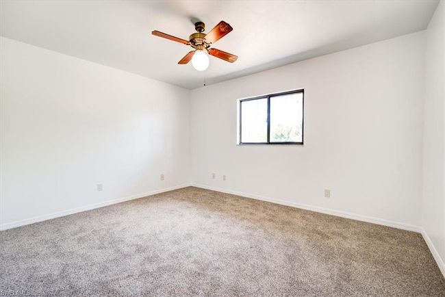 Empty room featuring ceiling fan, carpet floors, and baseboards | Image 23