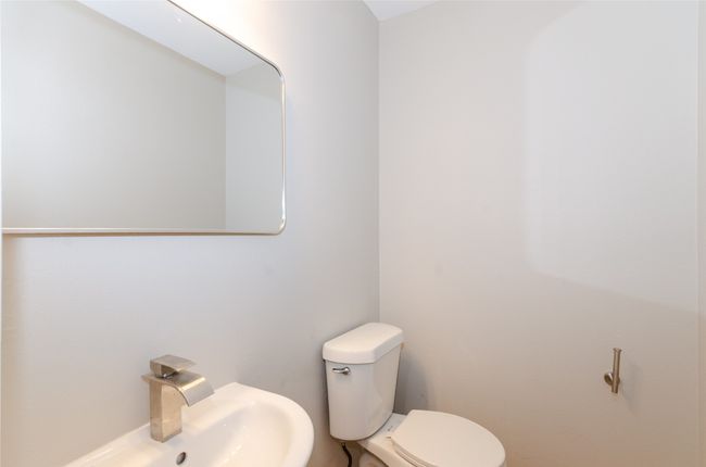 Bathroom with toilet and a sink | Image 13