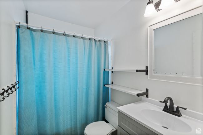 Bathroom with vanity and a shower with curtain | Image 11