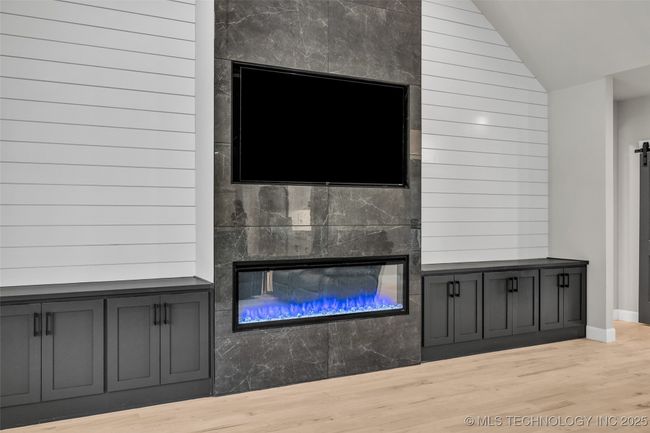 Electric fireplace with built-in cabinets and shiplap walls | Image 15