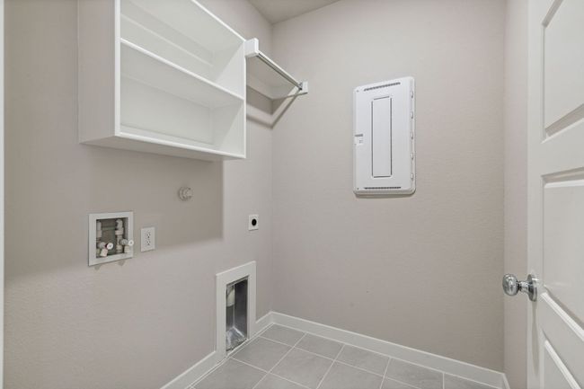 Clothes washing area featuring electric dryer hookup, hookup for a washing machine, gas dryer hookup, tile patterned floors, and baseboards | Image 23