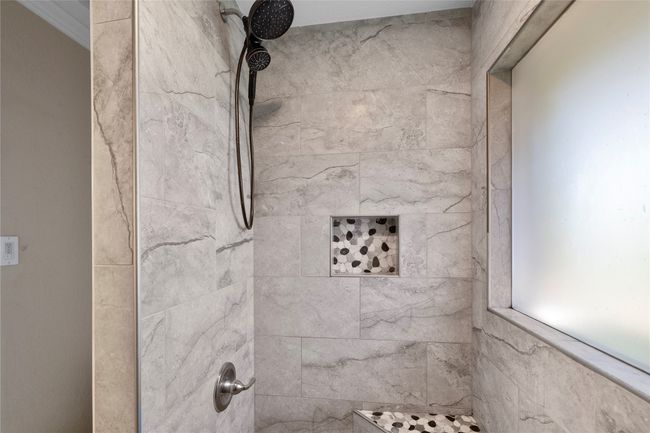 Bathroom view of a tile shower | Image 12