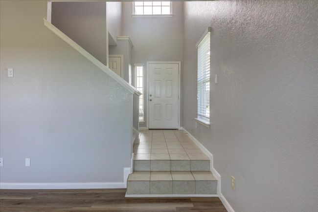 Looking back toward the front door and the staircase to the left leads to the slumber area. | Image 8