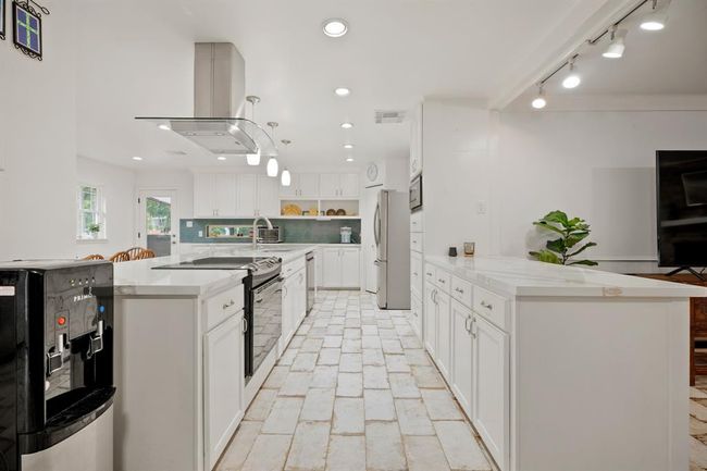 What a kitchen! Fully gutted and renovated. Sleek quartz countertops, soft close cabinetry offering an abundance of storage and countertop space. | Image 9