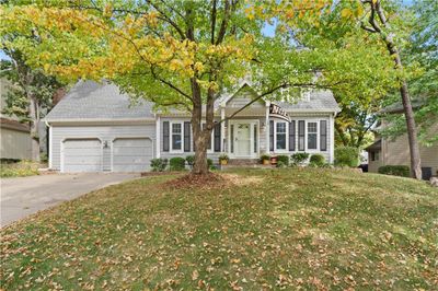 View of front of property with a garage and a front lawn | Image 1