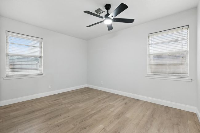 Primary bedroom featuring healthy amount of natural light, light wood-type flooring, and baseboards | Image 12