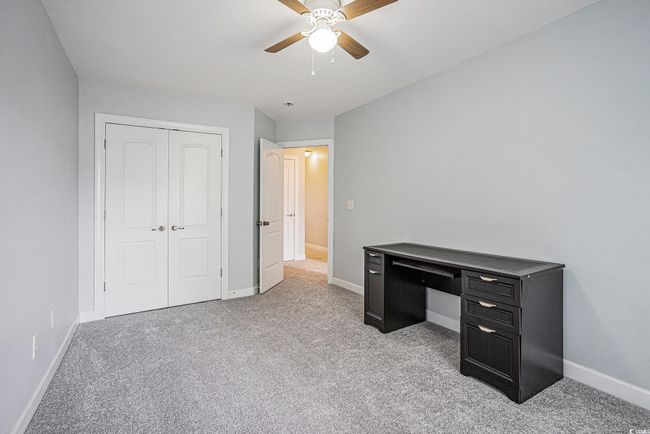 Unfurnished office with light colored carpet and a ceiling fan | Image 16