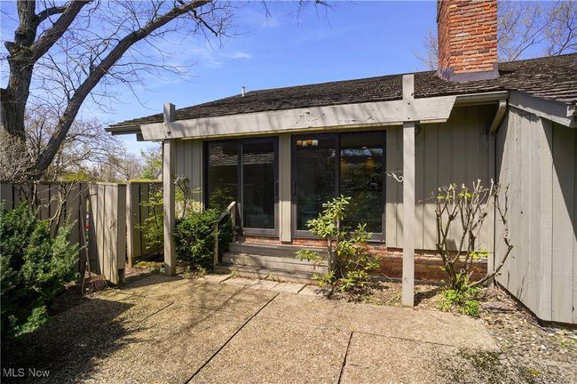 Back of property with fence, a patio area, a chimney, and entry steps | Image 45