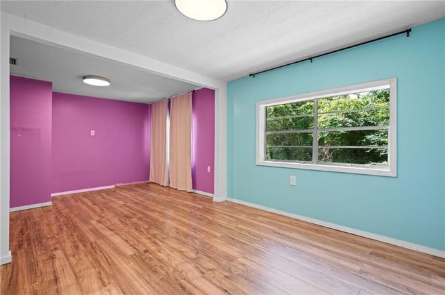 Empty room with wood finished floors and baseboards | Image 13
