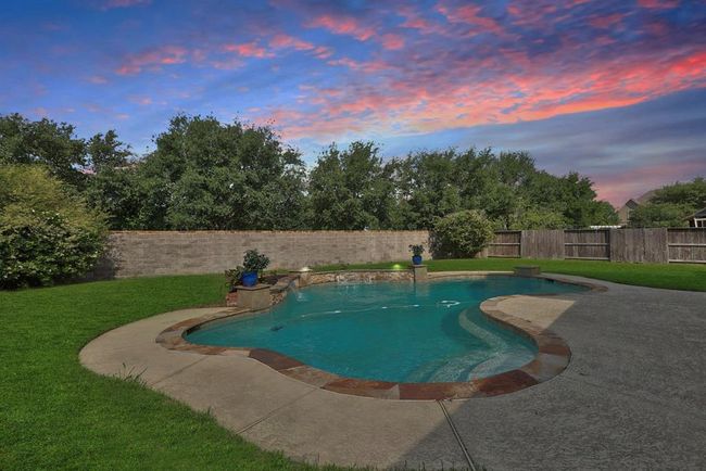 Well planned pool location for this large lot backing to HOA maintained brick fence. Full row of trees also maintained by HOA. Provides the privacy factor. Gated Northlake of Gleannloch Farms.More than 8.5 miles of trails, three recreation centers & seven parks lay the foundation for unlimited fun at Gleannloch Farms. Horseback riding, 2.5 acre fenced dog park w/ agility equipment, fishing, canoeing, tennis swimming and athletic fields and the on-site Frank Elementary which is walkable from this home. | Image 4