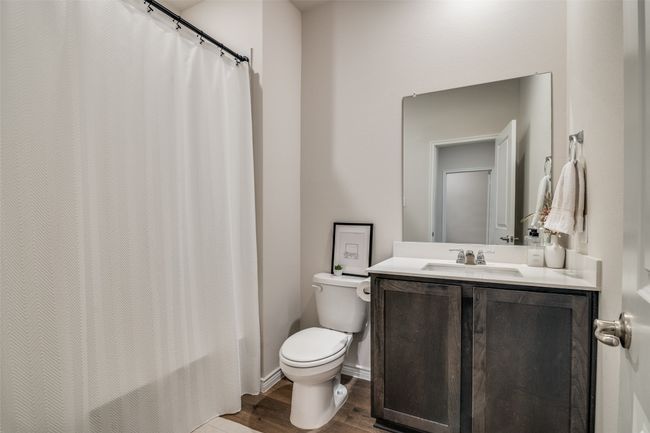 Bathroom with wood finished floors, vanity, and a shower with curtain | Image 24