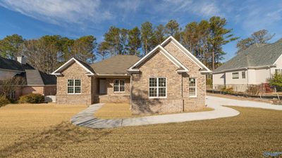 Digitally added sod to photo to give a better idea what home would look like once sod is laid. | Image 1