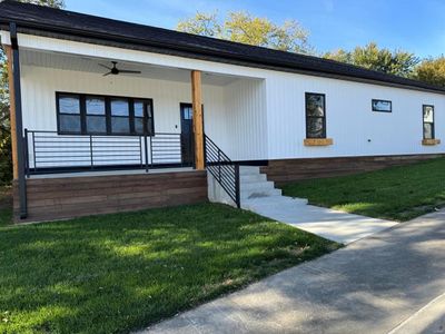 View of front facade featuring ceiling fan and a front yard | Image 2