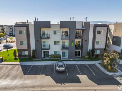 View of building exterior featuring a mountain view and central air condition unit | Image 1