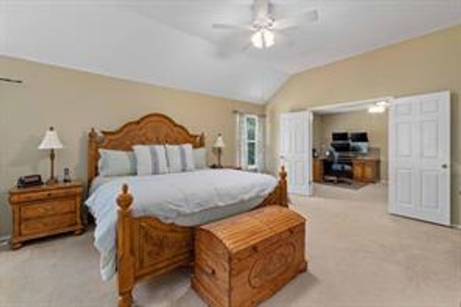 Carpeted bedroom featuring lofted ceiling and a ceiling fan | Image 23