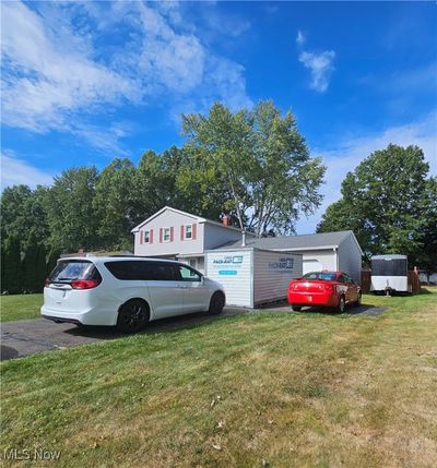 View of side of property with a yard and a storage unit | Image 3