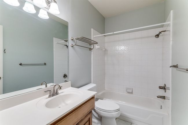 Jack-and Jill Bathroom featuring vanity, washtub / shower combination, and toilet | Image 22