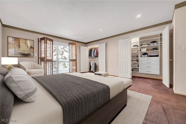 Virtually staged. Primary bedroom on 1st has sliding door to deck, double closets, one of which has built-ins, room for sitting area. There are two full baths off the hallway making it possible for his and her baths or guest bathroom | Image 21