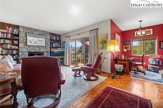Stone fireplace with gas logs. Pretty floors have been installed throughout where there was once​​‌​​​​‌​​‌‌​‌‌​​​‌‌​​‌‌​‌​​​​​‌ carpet | Image 9