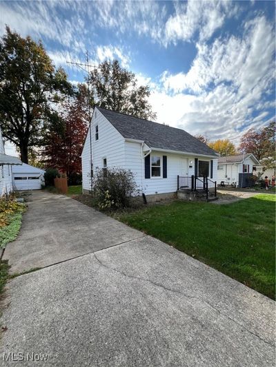 View of front facade with an outdoor structure, a garage, and a front lawn | Image 3