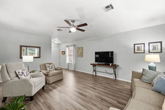 Living area with a ceiling fans, high ceiling | Image 5