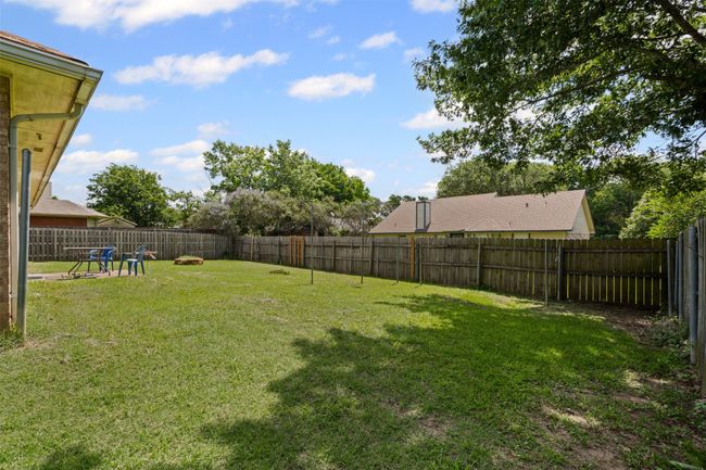 View of fenced backyard | Image 25