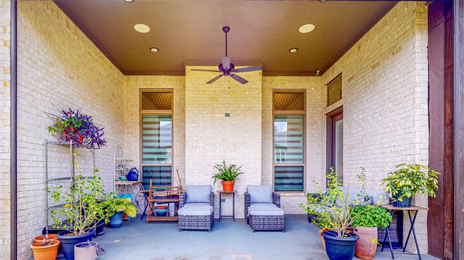 Covered porch featuring a ceiling fan | Image 38