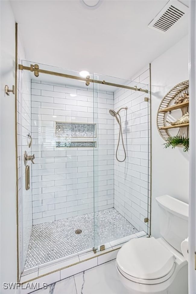 Full bathroom featuring toilet and a shower stall | Image 32
