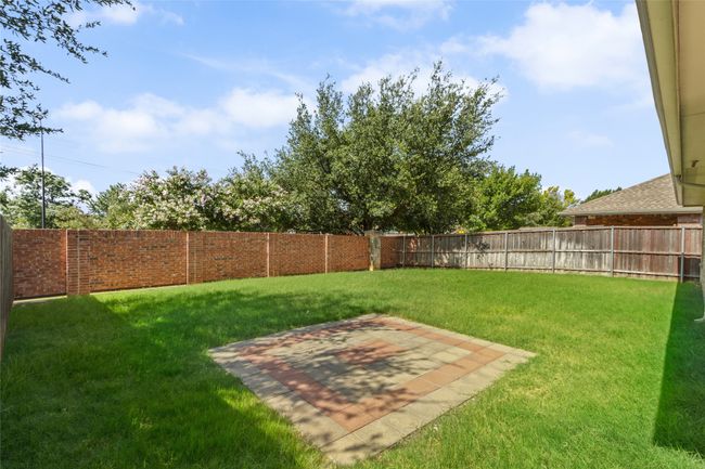 Fenced backyard with a patio area | Image 27