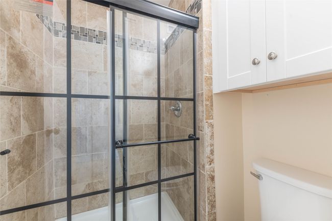 Bathroom with tiled shower and toilet | Image 21
