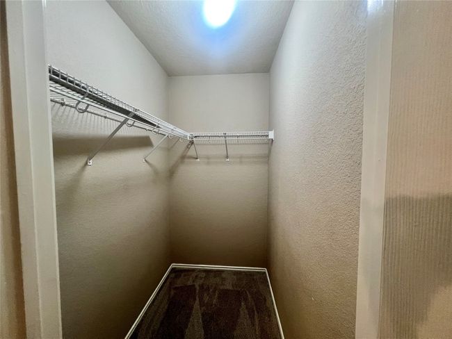 Walk in closet featuring carpet | Image 31