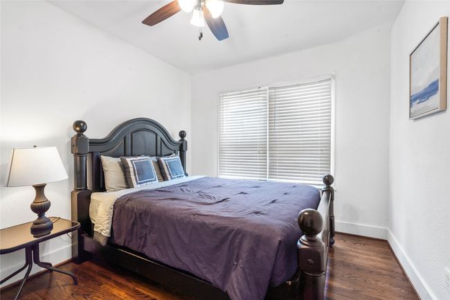 Bedroom with wood finished floors and ceiling fan | Image 20