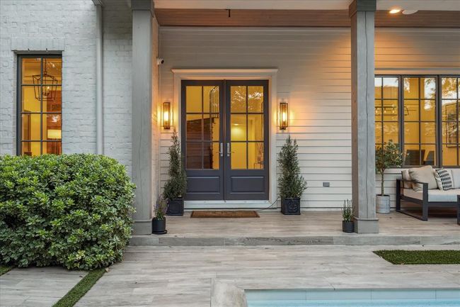 EXTERIOR. One of many doors down the east side of the home which can be opened up onto the pool area. | Image 30