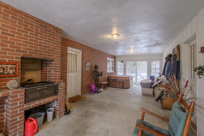 Breezeway between house and Garage features a wood-burning grill!! And a hot tub. | Image 15